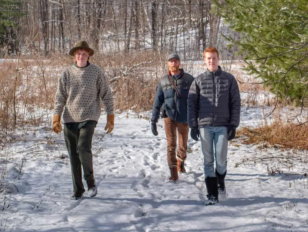 Rown, Eric, and Gabe walking through the snow on a winter day.