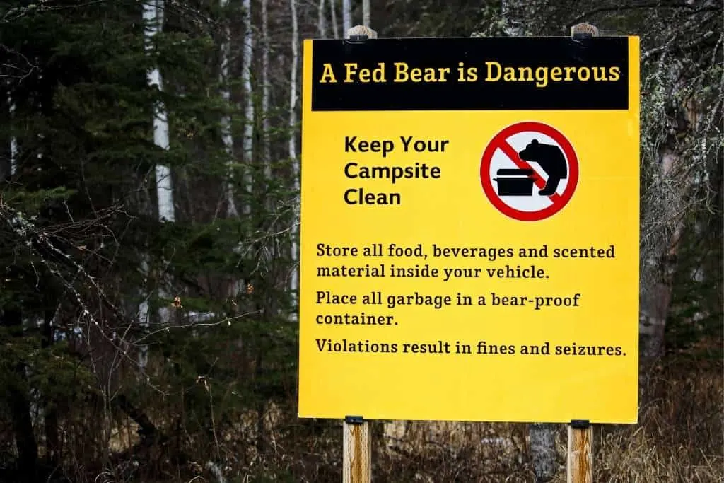 A campground sign warning campers about attracting bears to their campsites by leaving food out.