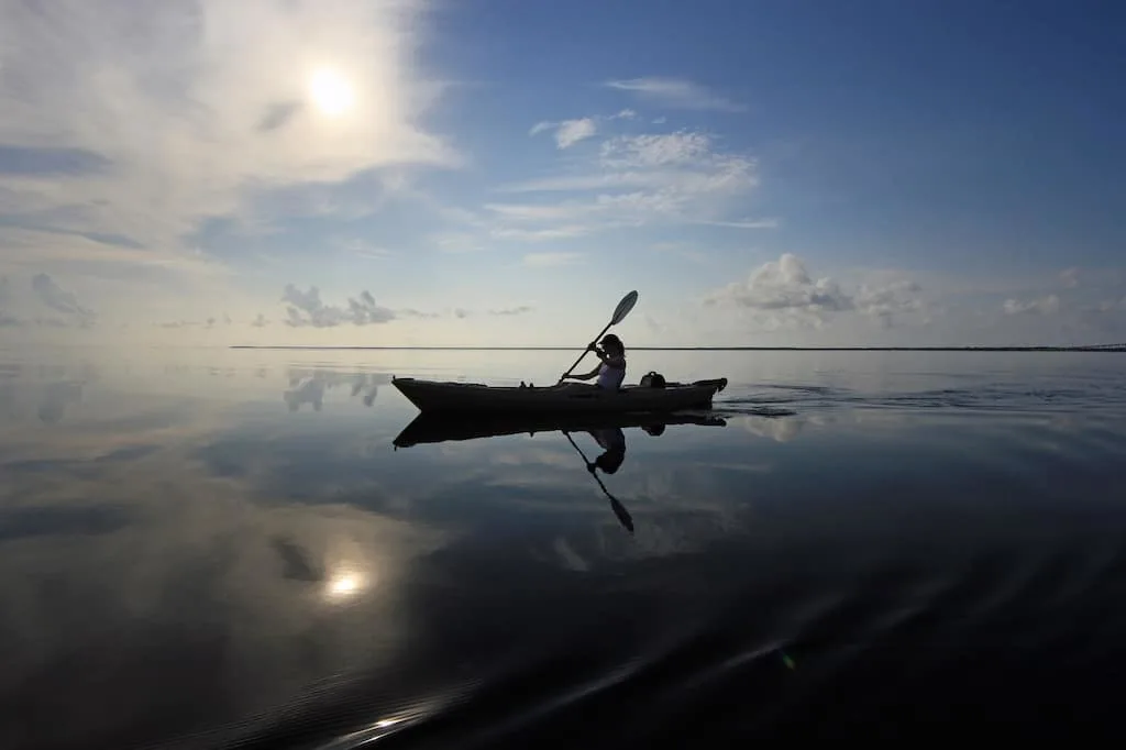 A woman paddles on the calm waters of Biscayne Bay in Florida.