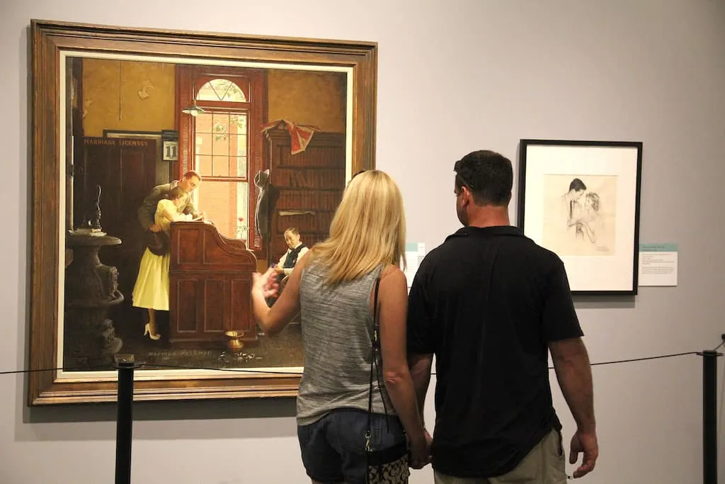A couple looking at a painting in the Norman Rockwell Museum in Stockbridge, MA.