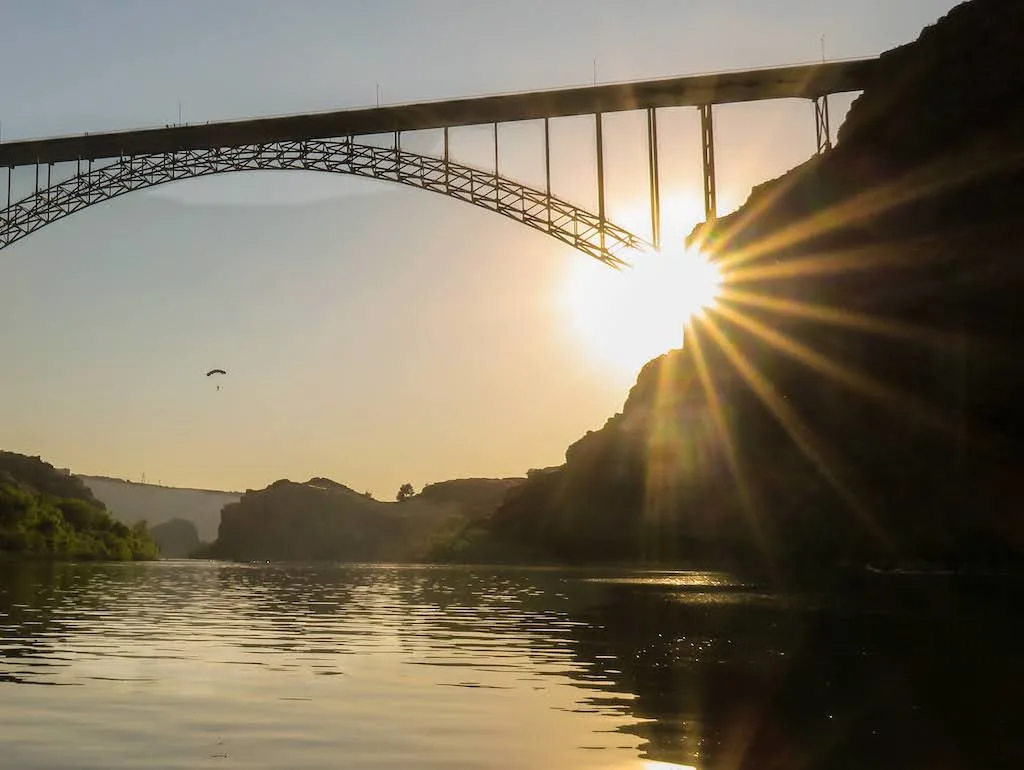 A sunset view of the Perrine Bridge in Twin Falls, Idaho. There is a BASE jumper in the distance.