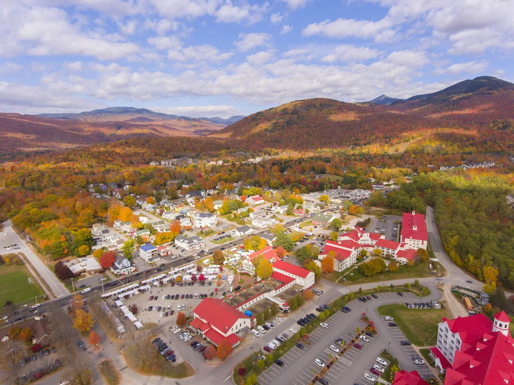 An aerial view of downtown Lincoln, New Hampshire and RiverWalk Resort in the fall.