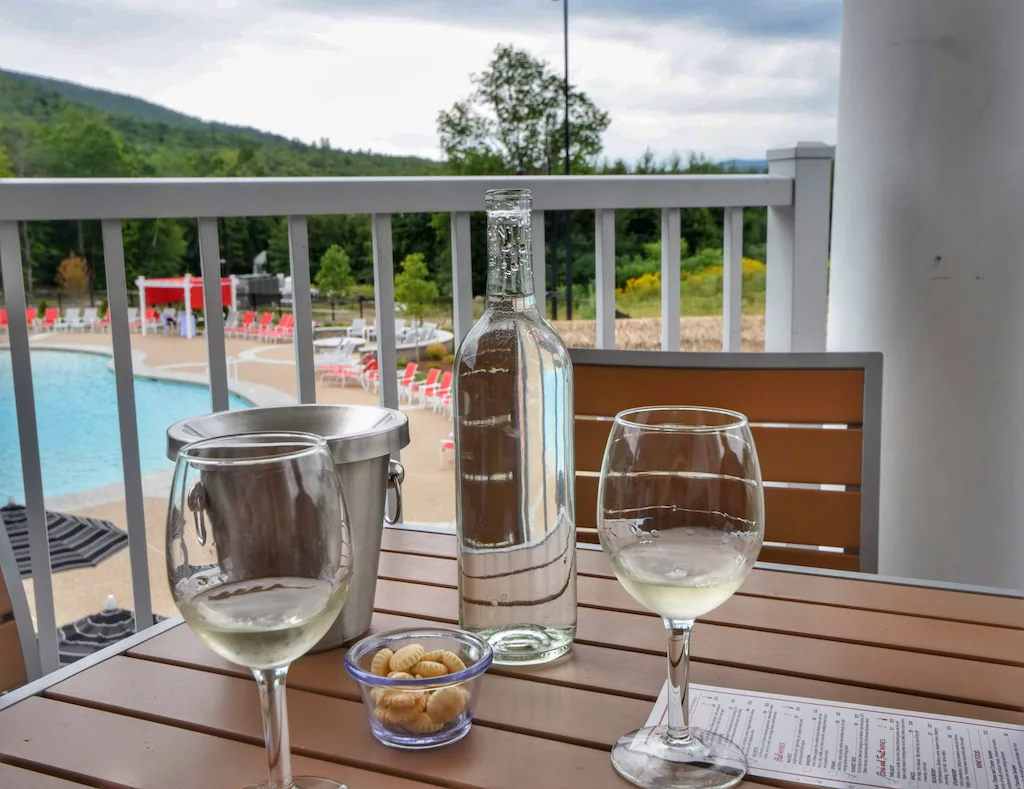 Two glasses of wine on a table on the balcony at RiverWalk Resort at Loon Mountain in Lincoln, New Hampshire.