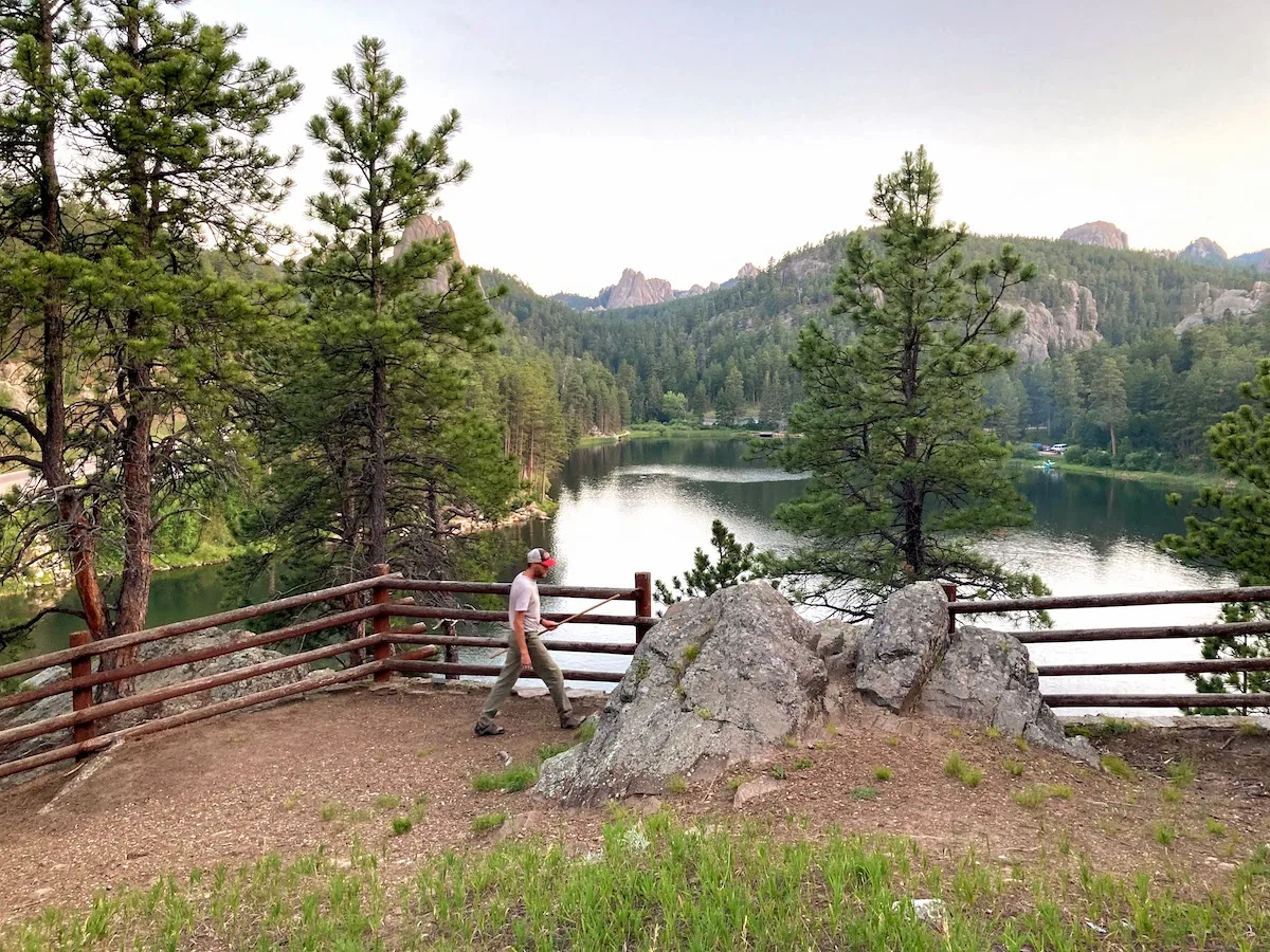 A man walks along the overview of Horsethief Lake in the Black Hills of South Dakota.
