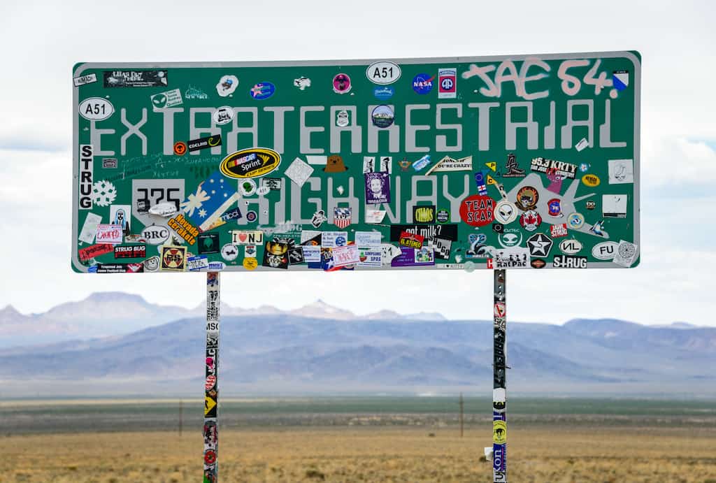 A road sign for the Extraterrestrial Highway covered with stickers in Nevada.