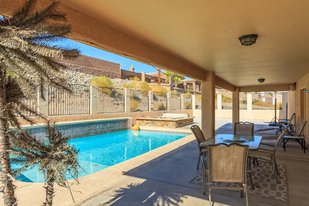 A covered patio looking out onto a spacious pool at a vacation rental in Lake Havasu City, AZ. Photo credit: VRBO
