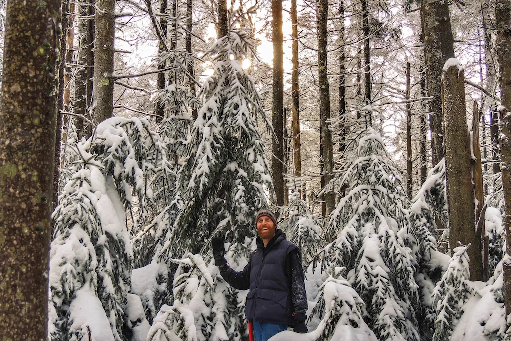 Eric standing next to our perfect wild Christmas tree.