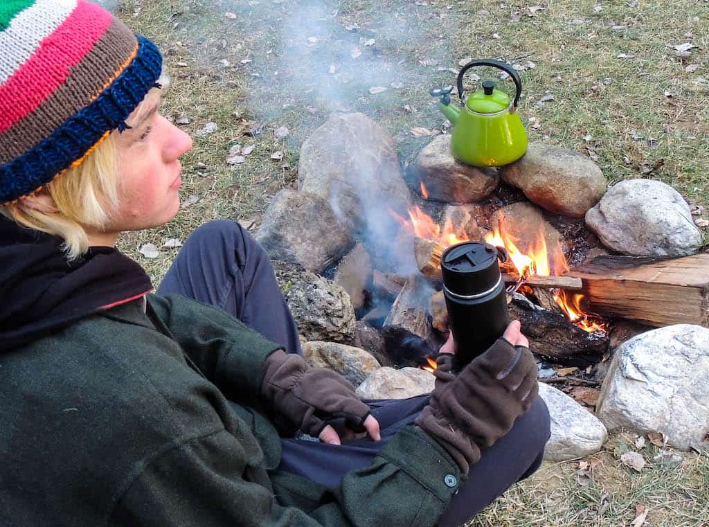 Rowan sitting near a campfire.