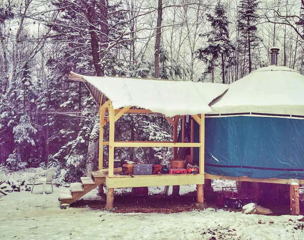 A snowy view of a yurt for rent in New Hampshire.