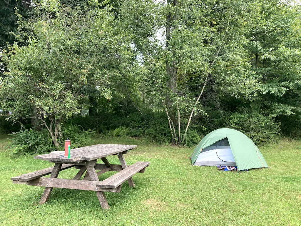 A small green tent next to a picnic table at the Hickory Run State Park Campground.