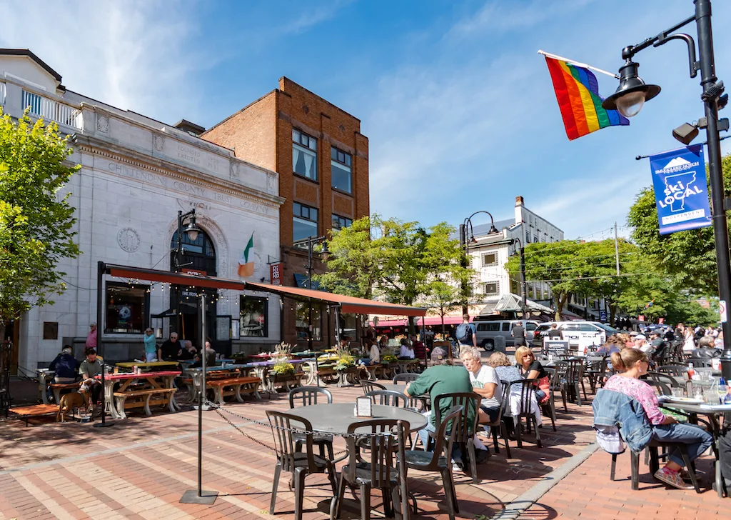 A crowd of people enjoying the outdoor patios on Church Street in Burlington Vermont.