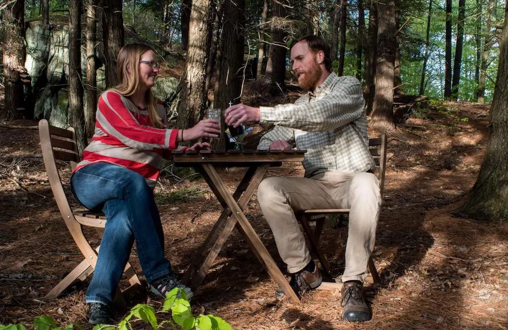 Tara and Eric share a glass of wine outdoors.