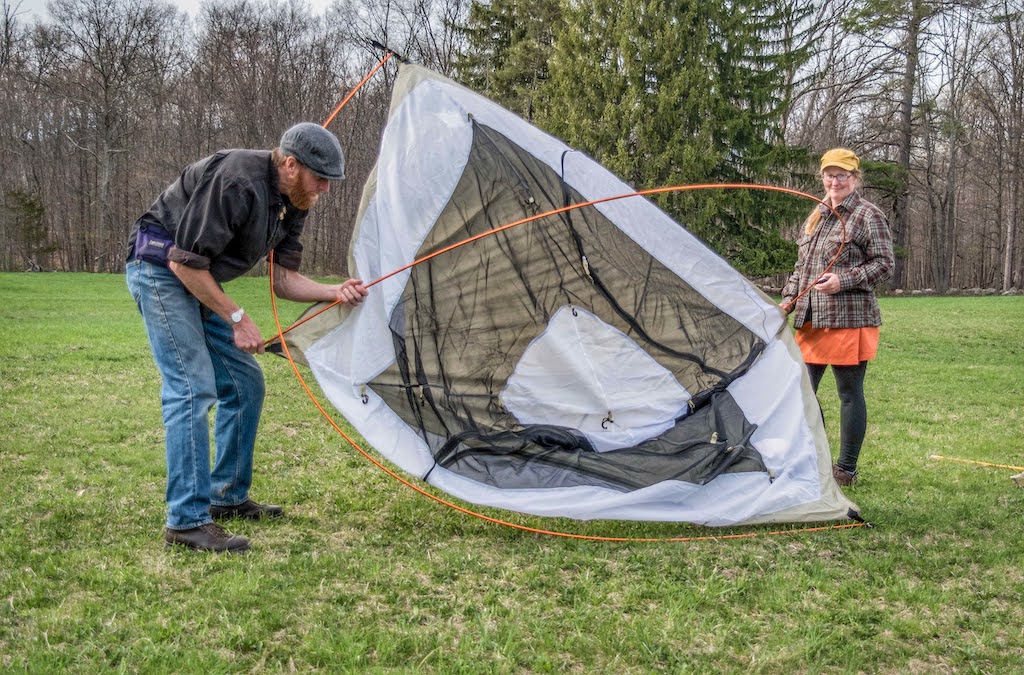 Tara and Eric set up a tent together.