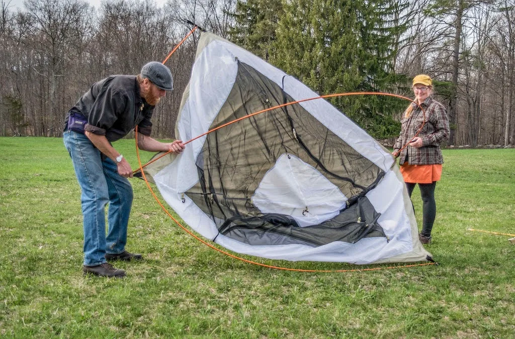 Tara and Eric set up a tent together.