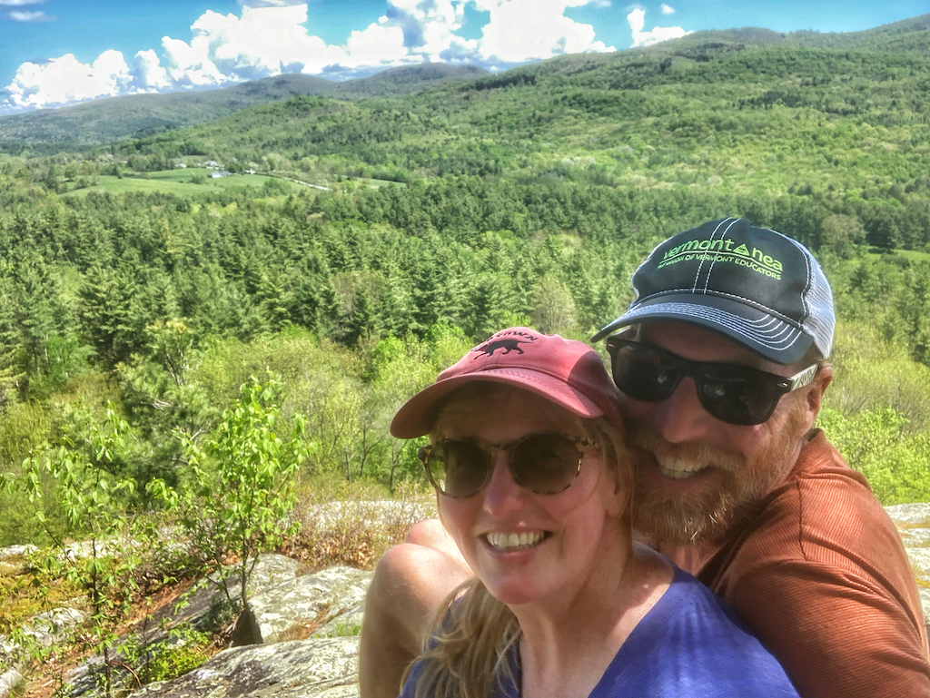 Tara and Eric posing for a selfie while hiking in the Green Mountains.