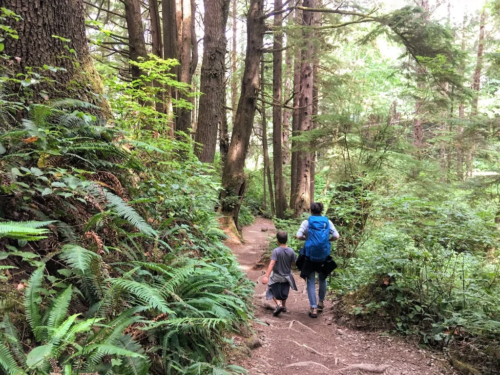 A woman and young boy hike on a trail in Sol Duc Valley in Olympic National Park.