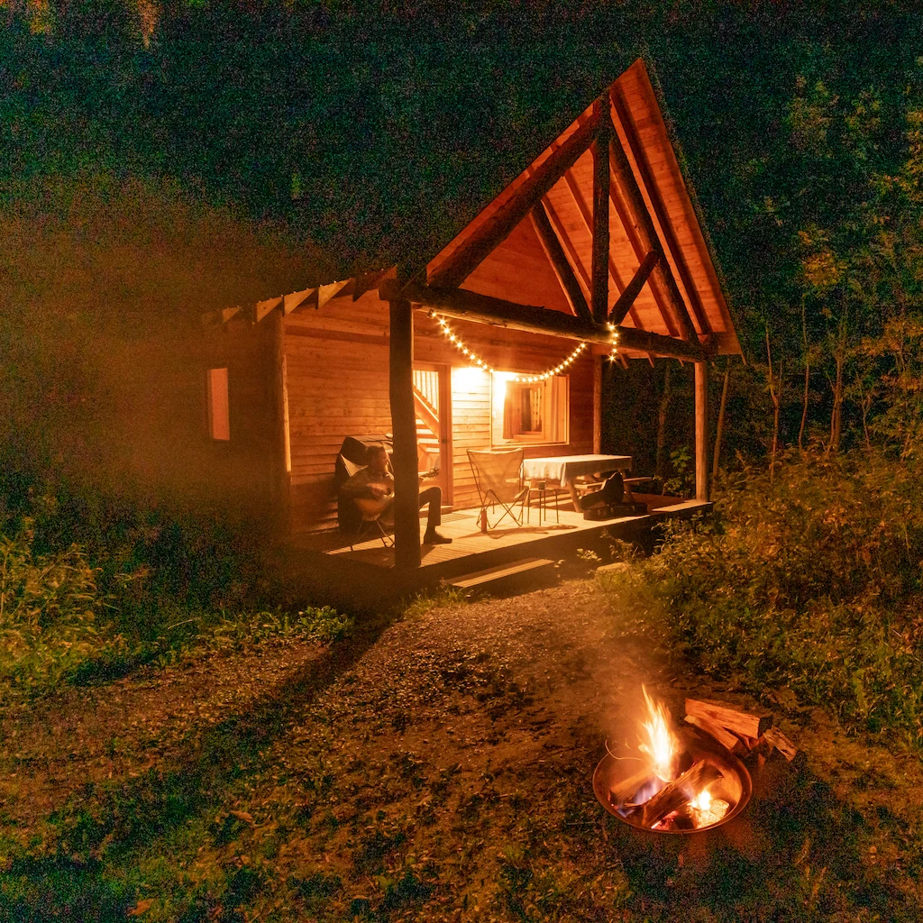 A cabin at night at Huttpoia Sutton in Quebec. 