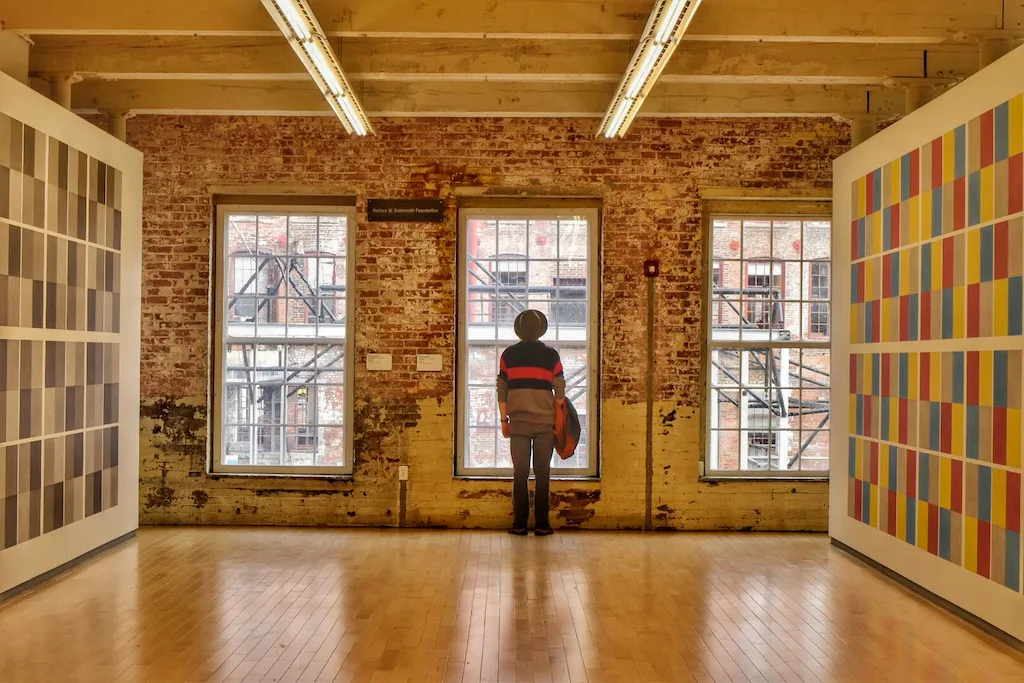 a man stands in a gallery in Mass MoCA in the Berkshires.