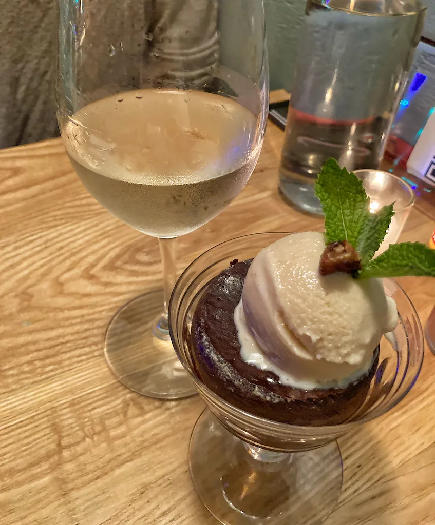 Desert of flourless chocolate cake with ice cream and white wine at Methuselah Bar and Lounge in Pittsfield, MA.