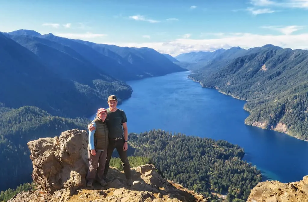 Rowan and Tara standing on Storm King Mountain with a view of Lake Crescent in the background.