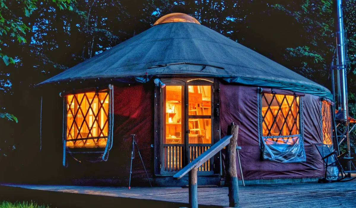 A yurt in the Finger Lakes of New York lit up at night.