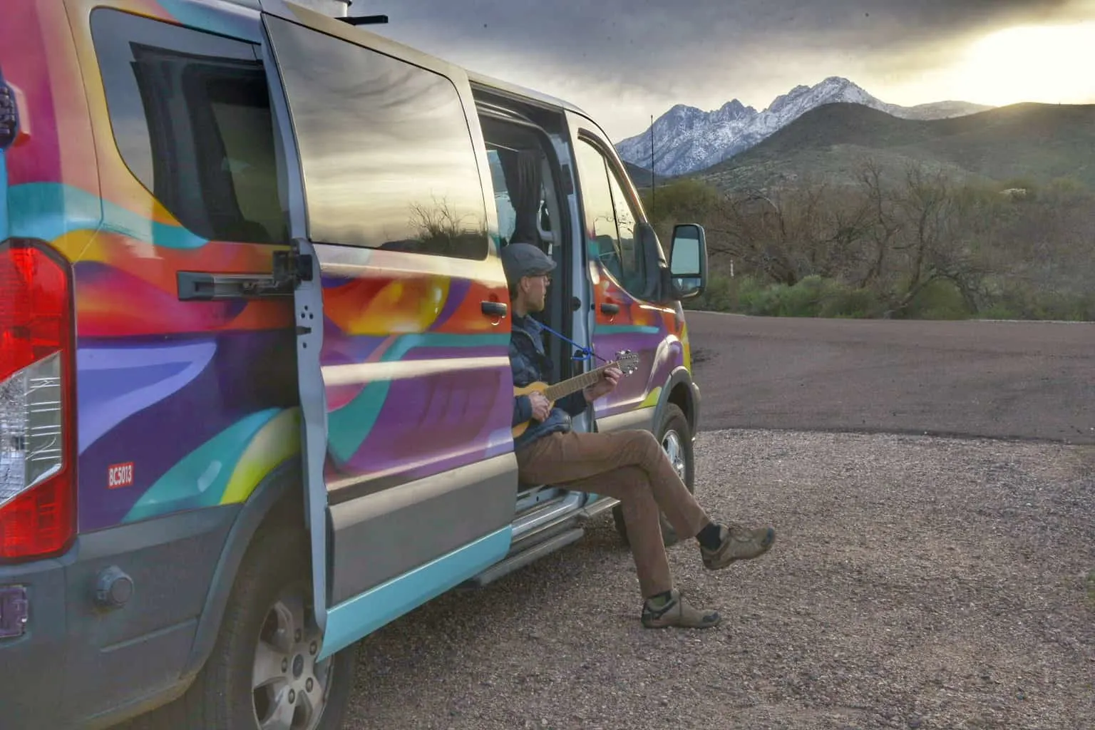 Eric playing a little guitar in our Escape Campervan rental.