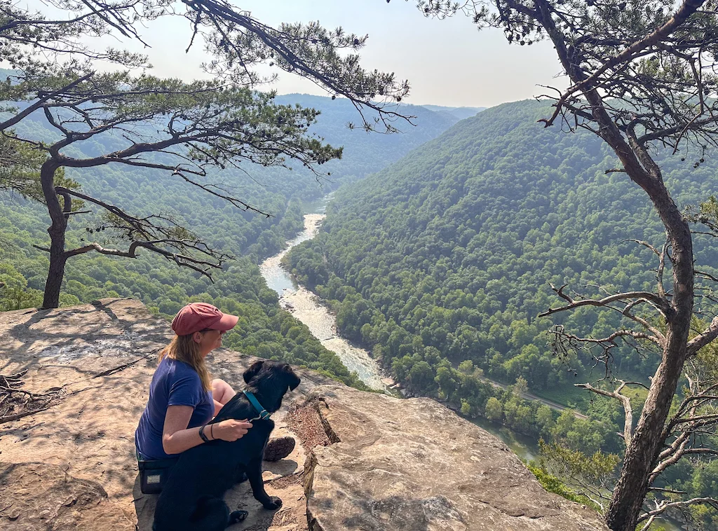 Tara and Malinda sitting on a rocky outcropping look out over the New River in West Virginia.