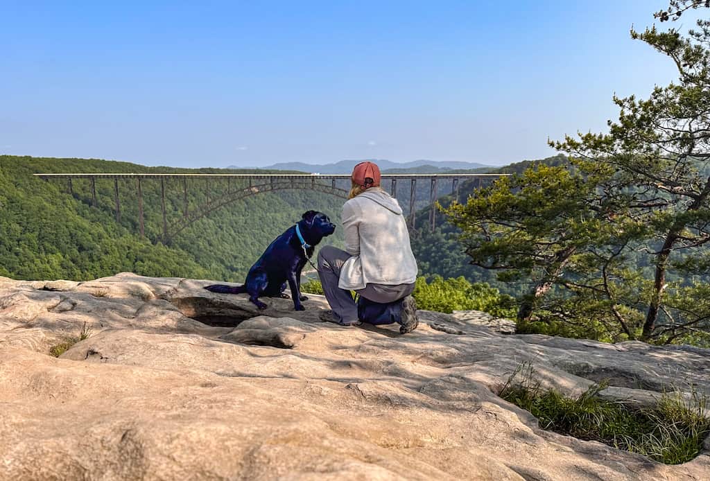 Malinda and Tara sit on a rocky outcropping at the end of Long Point Trail in New River Gorge National Park in West Virginia.