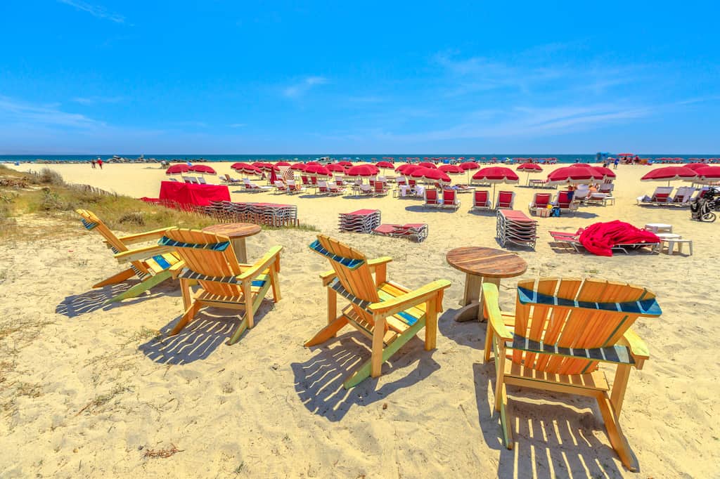 Chairs and bright red umbrellas on Coronado Beach in California. 