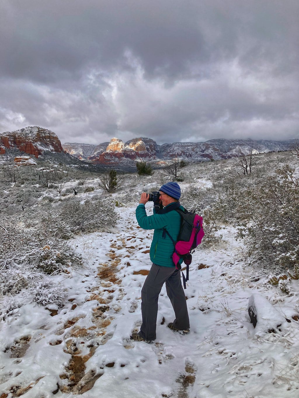 Tara taking photos in Sedona, which is covered with snow. 