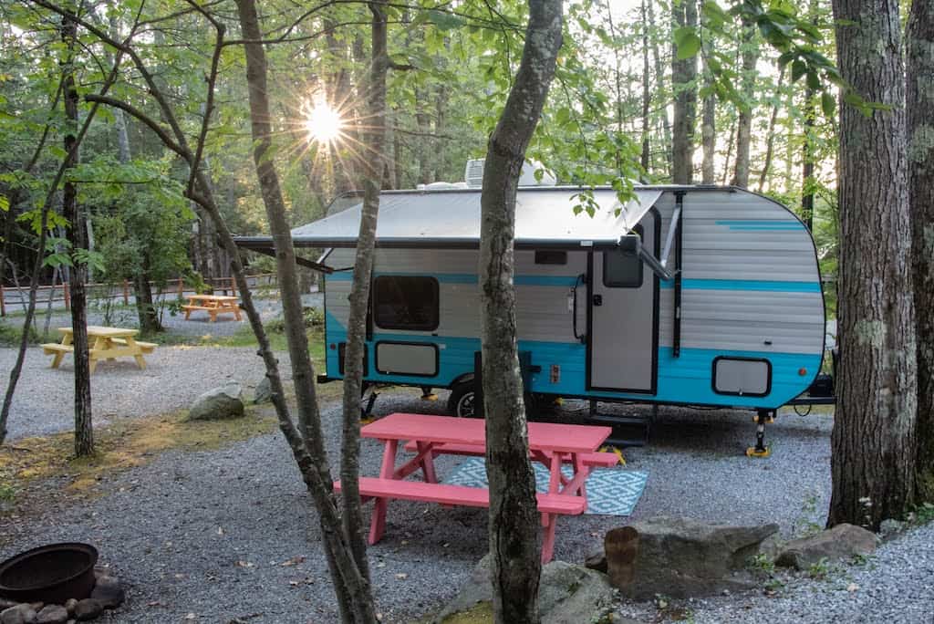 A small RV in a campground in New Hampshire. 