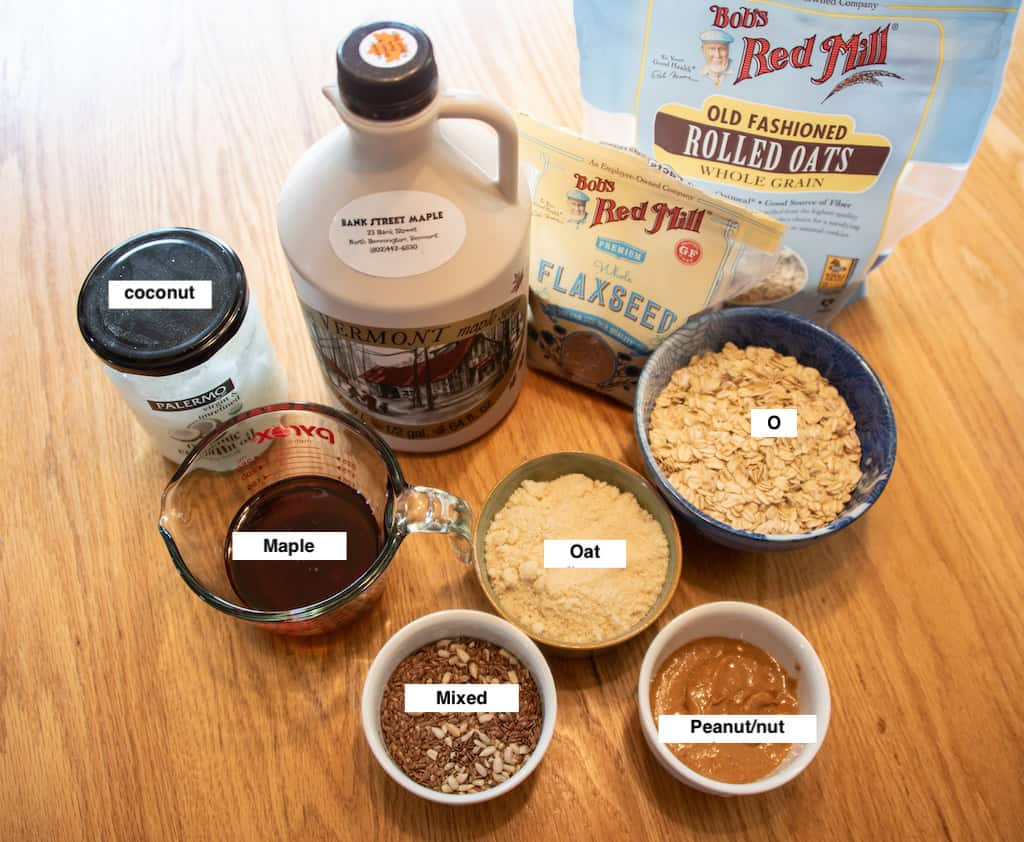 A photo of all the ingredients used to make these trail bars for hiking - maple syrup, oat flower, oats, coconut oils, seeds, and peanut butter. 