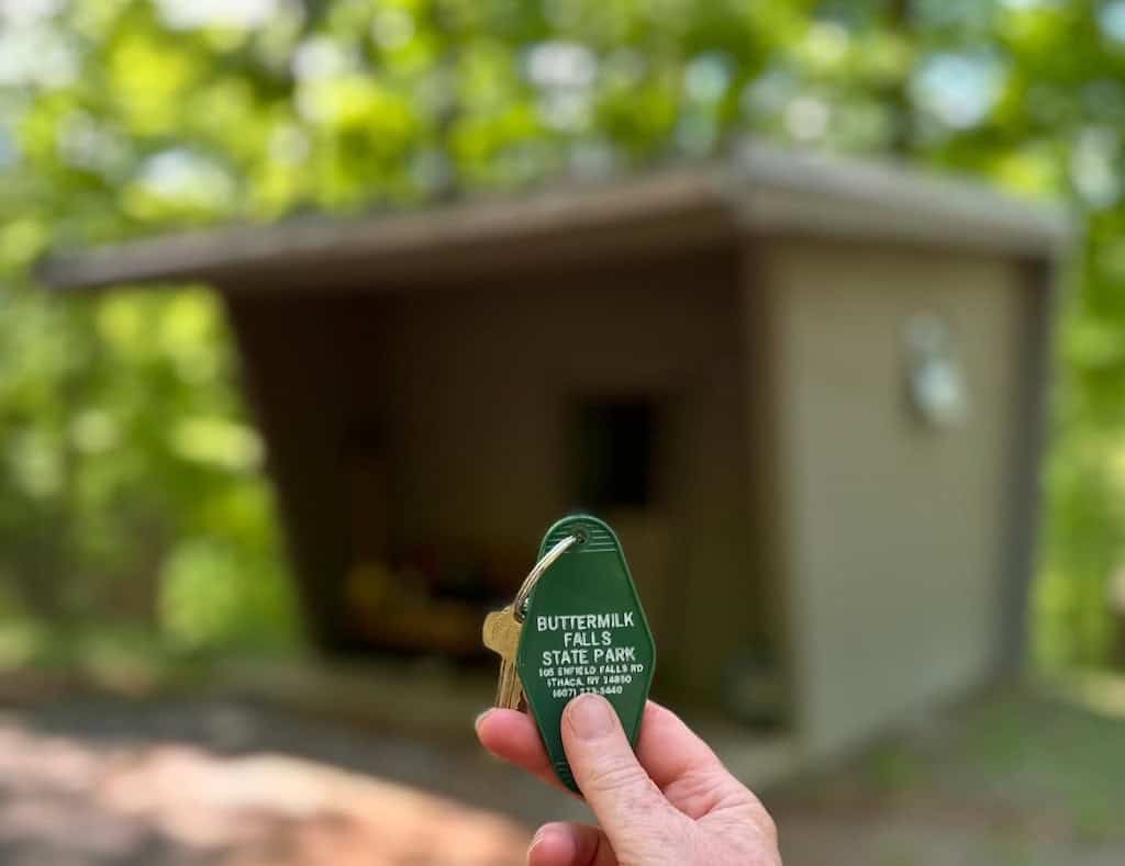 A key in front of a small camping cabin in Buttermilk Falls State Park in Ithaca.