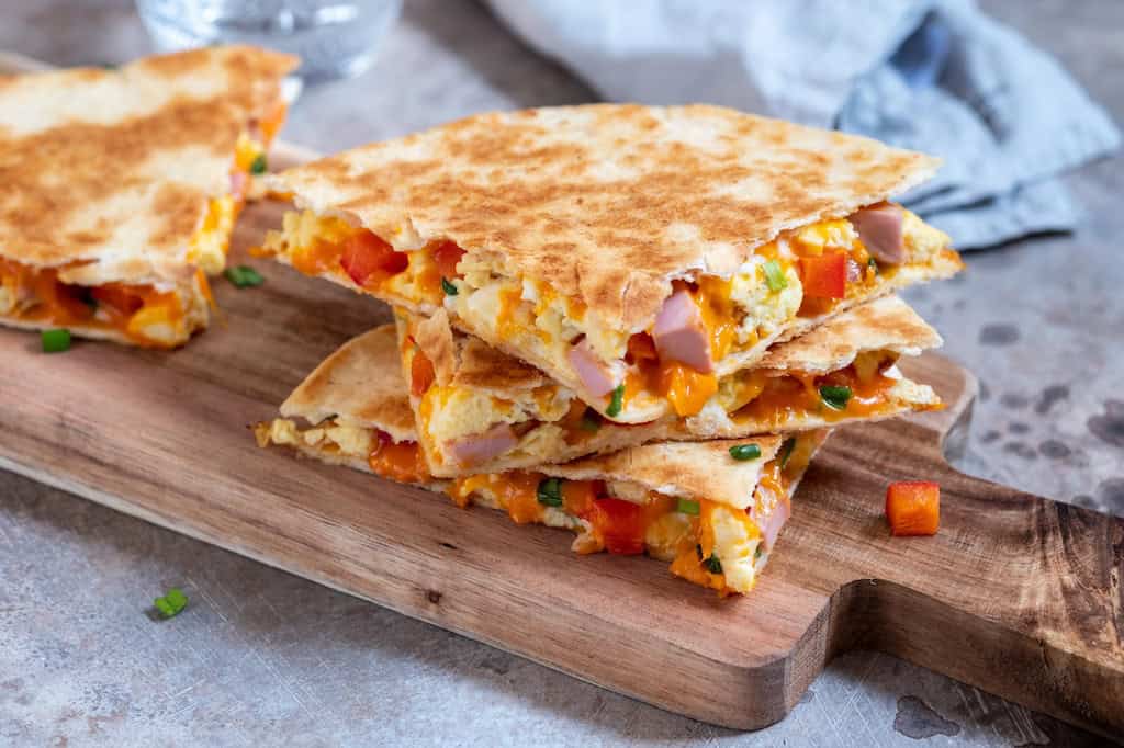 breakfast quesadillas on a cutting board.