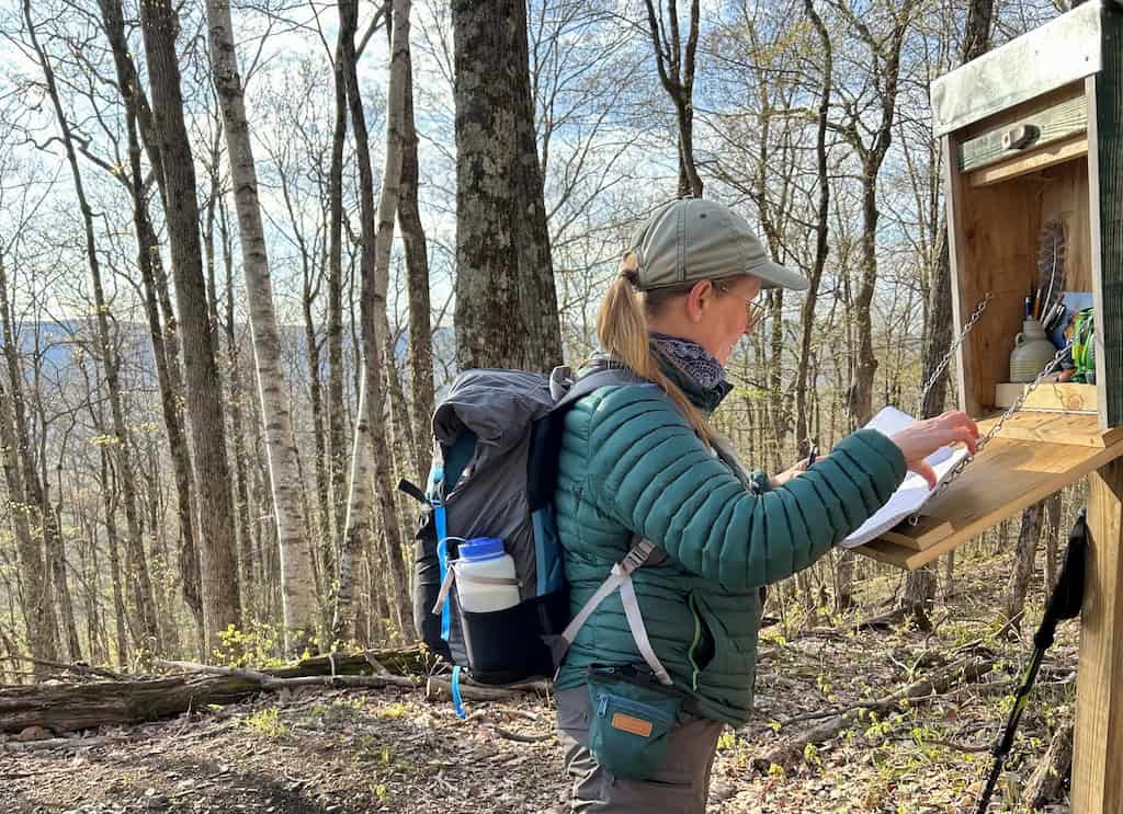 Don't Forget These 10 Essentials on Your Next Day Hike 4 Tara signing into a hiking registry in Vermont.