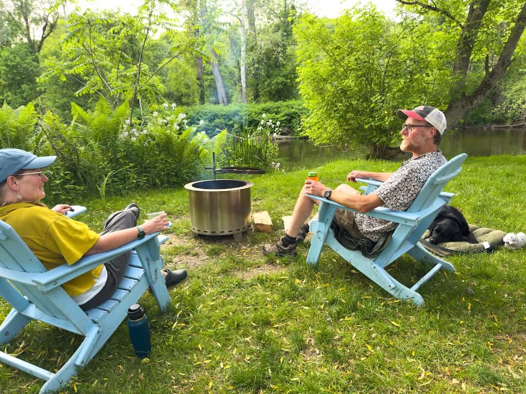 Tara and Eric sitting by the fire pit, just watching the river.